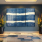 a blue and white painting on a wall in a room