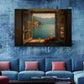 a large painting of a scenic view of a lake through an open window, with a small boat and baskets of fruit on the windowsill. The painting is hung on a blue wall above a blue couch with red throw pillows.