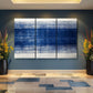 a blue and white painting on a wall in a room