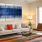 a living room filled with furniture and a painting on the wall