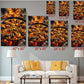 a living room with a white sofa and a coffee table. Above the sofa, there are several framed prints of the same image, depicting a large pan of seafood on a fire. The prints vary in size, ranging from 6 x 12" to 24 x 36". The prints are arranged in a grid-like pattern on the wall, creating a visually appealing display.