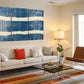 a living room filled with furniture and a painting on the wall
