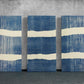 three blue and white paintings on a wall