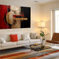 a living room with a white couch and a painting on the wall